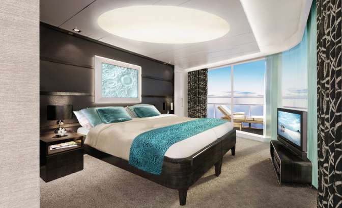De slaapkamer van de Owner Suite op de Norwegian Breakaway van NCL